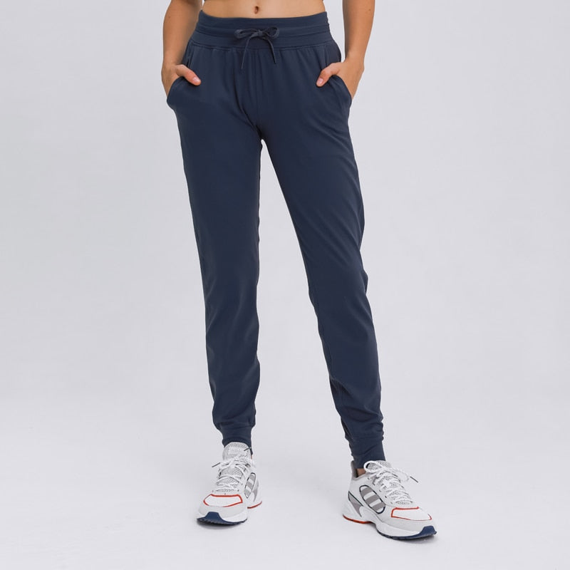 Women's Slim Fit Joggers - Comfortable and stylish sweatpants made from soft nylon material. Features drawstring waistband, cuffed ankles, and pockets. Built to last, perfect for any occasion. Elevate your wardrobe with these versatile joggers.