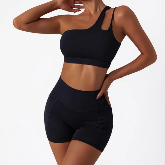 Troy Set - Premium breathable nylon/spandex blend for optimal comfort. Quick-dry technology keeps you confidently on the move. High-waisted shorts for trendy versatility. Unique one-shoulder sports bra with an elegant back design adds style to your workout. Elevate your active style with the Troy Set.