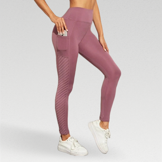 Enhance your workout experience with our Ribbon Leggings, meticulously crafted for comfort and style. The silky soft poly/broadcloth/spandex blend moves with you, providing flexibility and durability. The leggings feature beautiful side panel detailing for a luxurious touch. Stay comfortable with breathable fabric and enjoy the added support of a high waisted compression waistband. Mesh panels add ventilation and style, while pockets keep your essentials handy. 