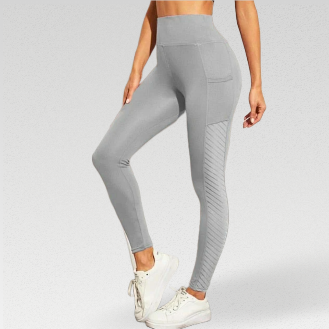 Enhance your workout experience with our Ribbon Leggings, meticulously crafted for comfort and style. The silky soft poly/broadcloth/spandex blend moves with you, providing flexibility and durability. The leggings feature beautiful side panel detailing for a luxurious touch. Stay comfortable with breathable fabric and enjoy the added support of a high waisted compression waistband. Mesh panels add ventilation and style, while pockets keep your essentials handy. 
