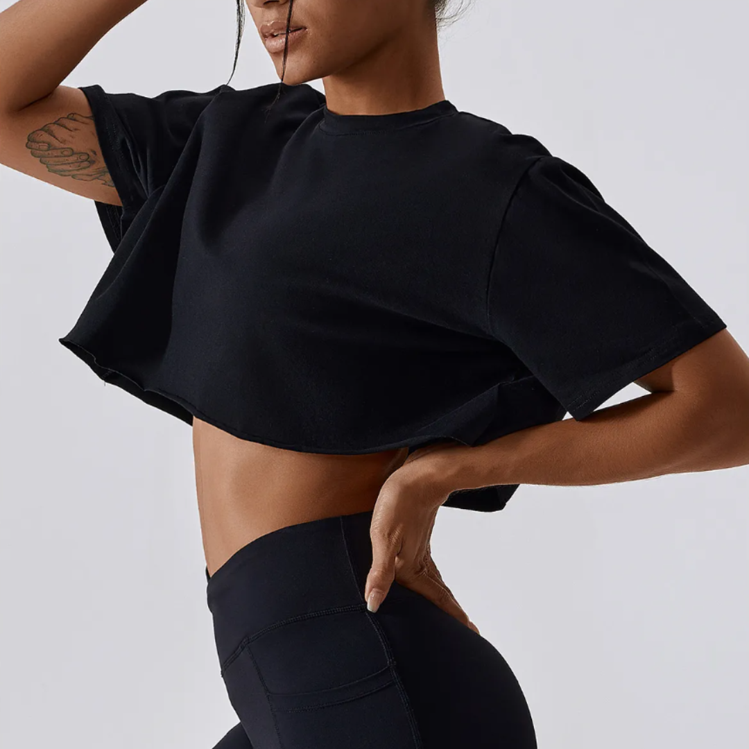 The Cali Cropped Crew Neck Tee, showcasing unparalleled comfort in a blend of cotton and spandex. Experience breathable comfort, quick-dry technology, and durable style effortlessly blended in this versatile tee for any occasion.