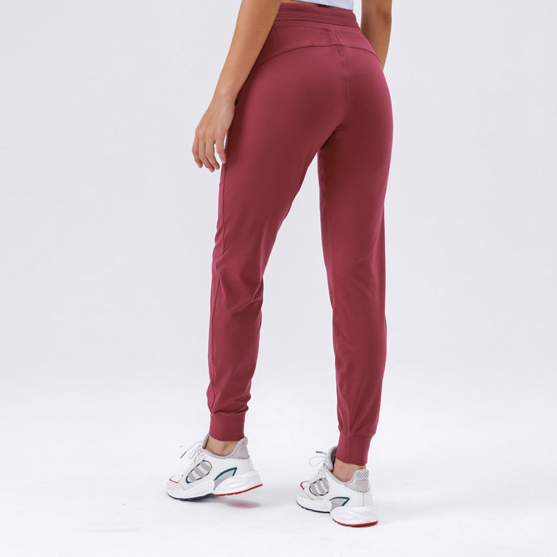 Women's Slim Fit Joggers - Comfortable and stylish sweatpants made from soft nylon material. Features drawstring waistband, cuffed ankles, and pockets. Built to last, perfect for any occasion. Elevate your wardrobe with these versatile joggers.