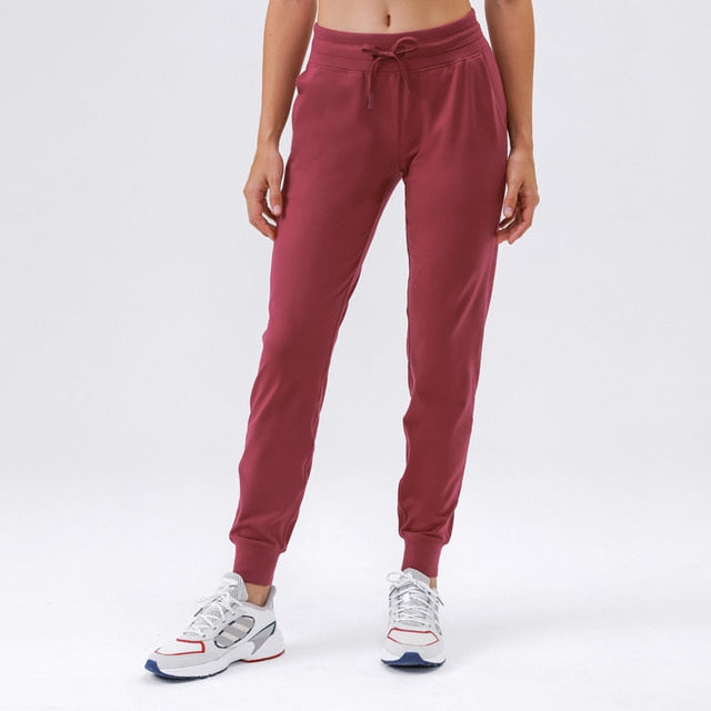 Women's Slim Fit Joggers - Comfortable and stylish sweatpants made from soft nylon material. Features drawstring waistband, cuffed ankles, and pockets. Built to last, perfect for any occasion. Elevate your wardrobe with these versatile joggers.
