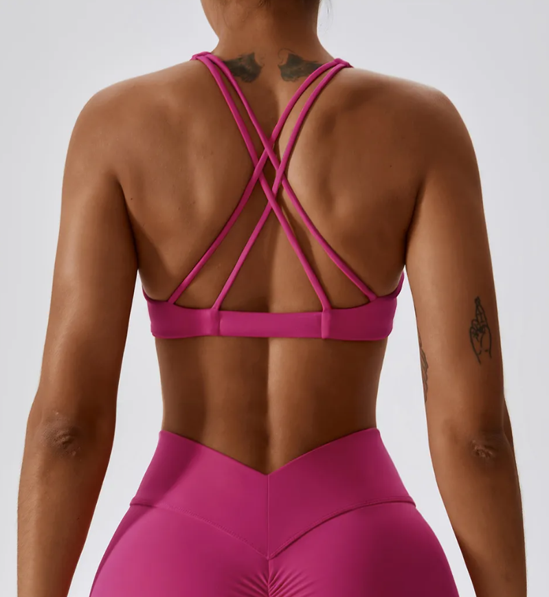 Ava Sports Bra - Premium nylon/spandex blend for ultimate comfort. Breathable design for active ventilation. Twist front and strappy cross back for stylish performance. Elevate your workout with the perfect fusion of style and comfort.