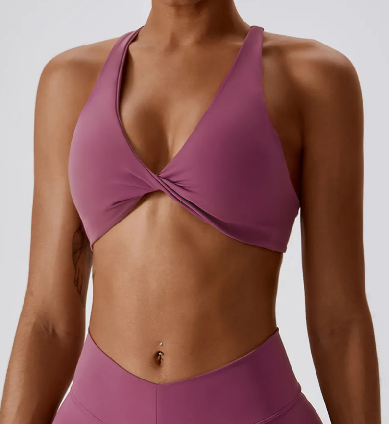 Ava Sports Bra - Premium nylon/spandex blend for ultimate comfort. Breathable design for active ventilation. Twist front and strappy cross back for stylish performance. Elevate your workout with the perfect fusion of style and comfort.